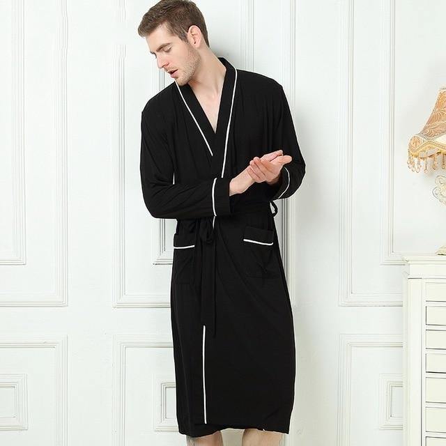 Man wearing black Bamboo Kimono luxury Spa Robe with white piping.  