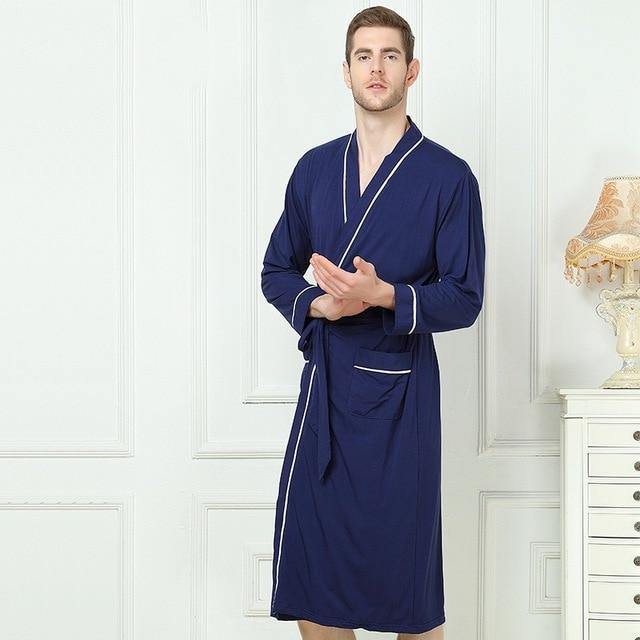 Man wearing blue Bamboo Kimono luxury Spa Robe with white piping. 
