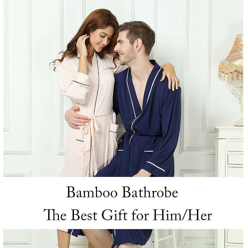 Man in Blue Bamboo Kimono luxury hotel spa robe with pink holding a woman around the waist who is wearing a light pink  with blue piping luxury Bamboo Kimono Spa Robe
